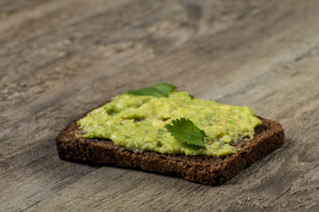 Guacamole sandwich closeup decorated with cilantro