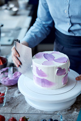 Holiday cake. Sweet desserts with berries and macarons. Cake from the fruit. Delicious sponge cake