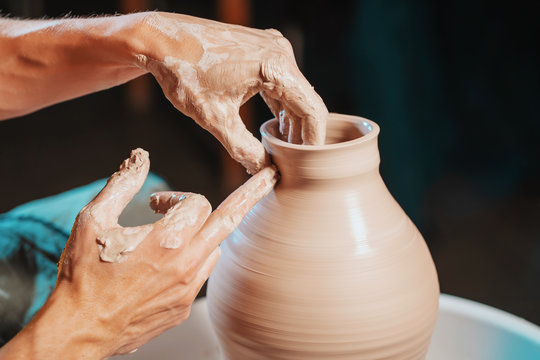 Unknown Craftsman Creates Jug. Focus On Hands Only. Small Business, Talent, Inspiration Concept. Overhead View. Working Process Of Man's Work At Potters Wheel In Art Studio