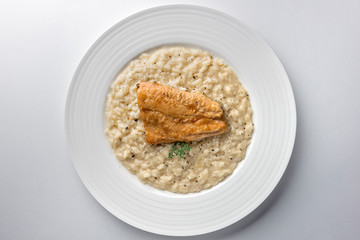 Dish of Parmesan risotto with fish fillet