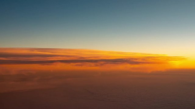 flying over clouds at sunset