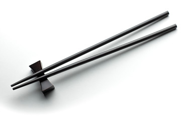 Black chopsticks on a white background