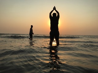Suryanamaskar on beach sunset