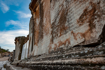 Close up ancient Greek inscription on stone block, Ephesus, Turkey.