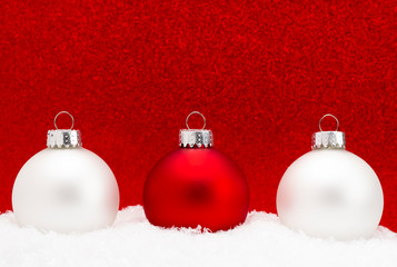 Christmas Ornament in the Snow with a Glittery Background