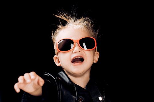 Stay wild and free. Little child boy in rocker jacket and sunglasses. Little rock star. Rock style child. Rock and roll fashion trend. Adorable small music fan. Music for children