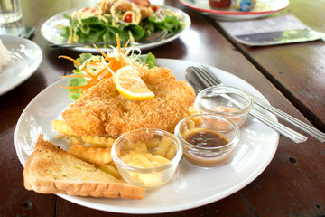 Battered fish steak with salad and vegetable