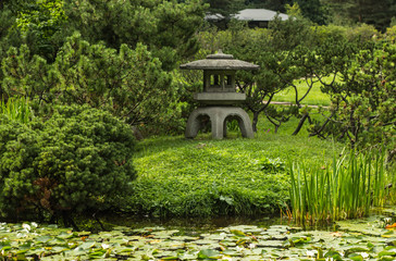 Stone lantern in a Japanese garden on a summer day.