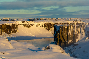 Jokulsa a Fjollum river near Dettifoss water at dawn on cold, snowy winters morning