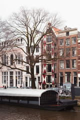Naklejka na ściany i meble Canal street view. Winter in Amsterdam
