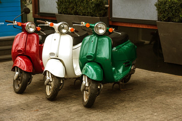 Motorcycles for pizza delivery, parked on the street, waiting for the order and delivery to the client. Mobile fast delivery of fresh hot pizza in the business part of the city