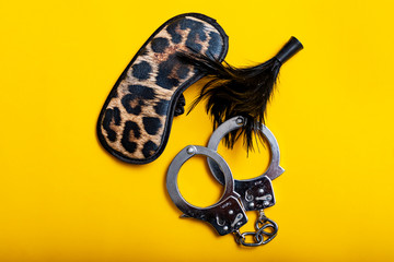 Sex concept. Different erotic toys on yellow background. © Sergi