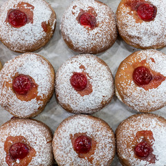 Fresh   donuts at bakery display for Hanukkah celebration. Selective focus.