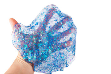 Hand holding a transparent blue glitter slime isolated on white.