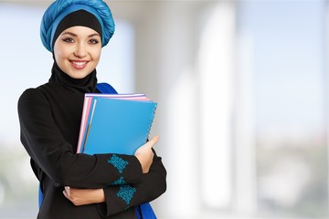 Close-up Beautiful Young Muslim Woman with notebooks  on blurred