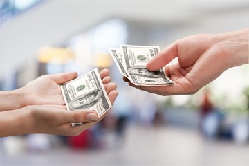 Two hands holding dollars banknote over  background