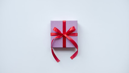 Pink gift box with red ribbon. Holiday present. Isolated on white background