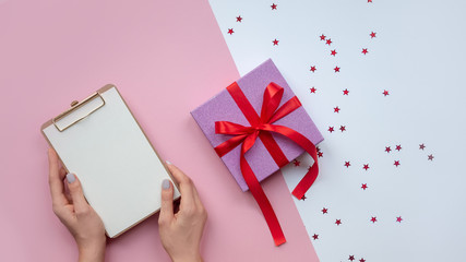 Flat lay . Woman's hands paper. To-do list. Christmas ideas, notes, goals or plan writing concept. Winter holidays. Merry christmas happy new year.