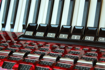 Beautiful old red accordion. Close-up. Background. Texture.
