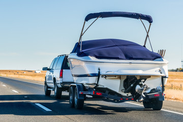 Truck towing a  boat on the interstate, California