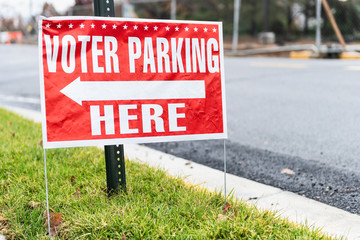 Voter parking here sign at school national federal polling election station with arrow on sidewalk,...