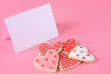 Close up of Valentine's day cookies with empty greeting card