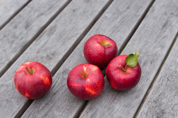 Organic fresh apples on wooden background. Agriculture concept theme with fresh apples in nature