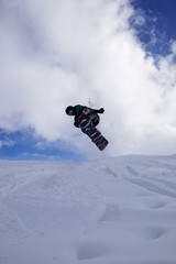 Naklejka na ściany i meble Snowboarder doing a jump