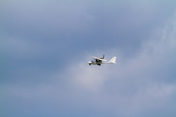 Fototapeta na wymiar Ultralight aircraft in the clouds