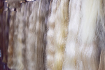 Hair extension equipment of natural hair. Hair ombre Balayage samples of different colors. Multi-colored strands, bunches, set for hair extension procedure