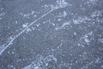 Asphalt with first snow - Illustration of frost and danger on the roads