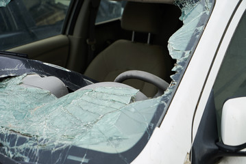 Broken car windshield, closeup. Damaged vehicle after car crash