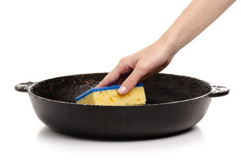 Old dirty fat pan clean sponge in hand. Isolation on a white background.