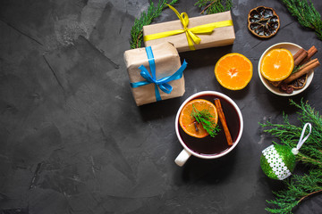 Mulled wine with spices and gifts on the table. Happy New Year! Top view