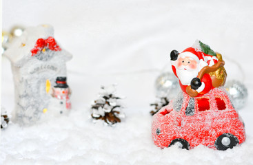 Santa Claus by car, house figurine, christmas. Background New Year, Christmas. place for text.