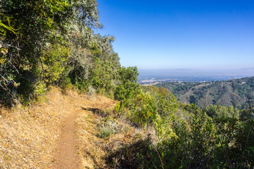 Hiking trail in Palo Alto Foothills Park, San Francisco bay area visible in the background, California