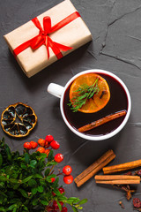 Mulled wine with spices and gifts on the table. Happy New Year! Top view