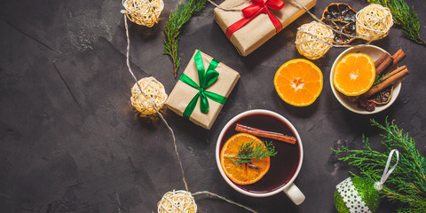 Mulled wine with spices and gifts on the table. Happy New Year! Top view