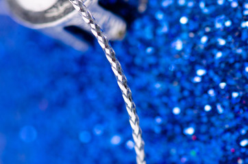 Fototapeta na wymiar Blue Christmas glitter toy macro decoration on blur background