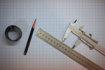 ruler and pencil on wooden background