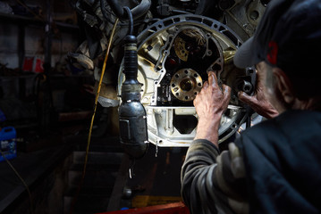 Mechanic repairman working and repair car engine in car service 