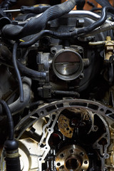 Obraz premium Car engine on crane hook in garage repair service, indoor