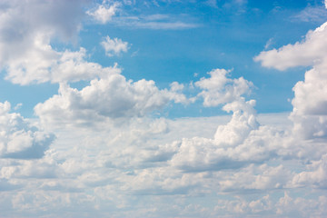 The vast blue sky with large group of fluffy clouds in sunny day of summer, peaceful skies background
