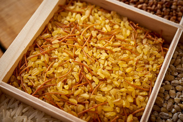 closeup of bulgur porridge in a wooden, square box