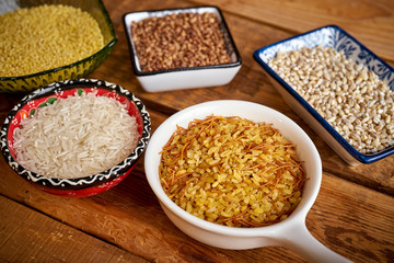 top view of several types of porridge in different bowls on an old wooden table