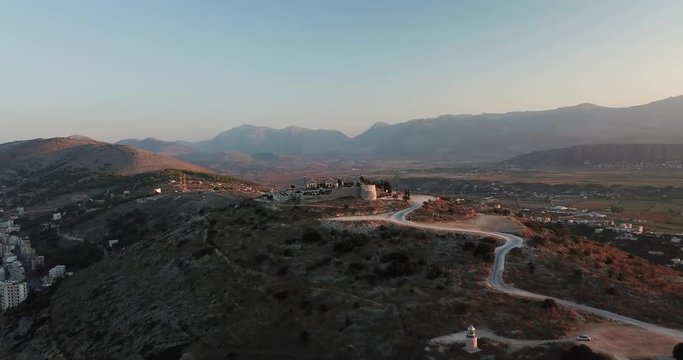 Aerial drone video in sunset of Lekuresi Castle located in Saranda, Vlora, Albania (Albania Riviera) - 4k