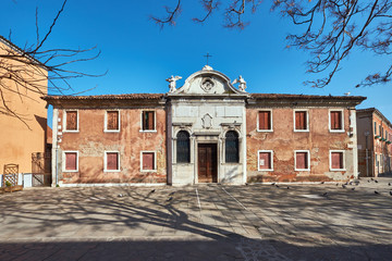 Tree shadows on top of old architecture of Murano, Venice, Italy.