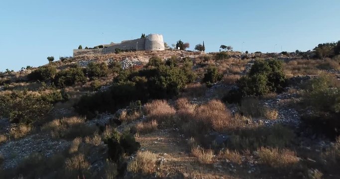 Aerial video of Lekuresi Castle in Saranda / Sarande in south Albania in the morning.  Beautiful Albanian castle sitting on top of a hill in the Albanian Riviera