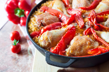 Chicken thighs and legs baked over a bed of rice and red bell pepper