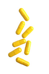 Yellow pill capsules isolated on white background